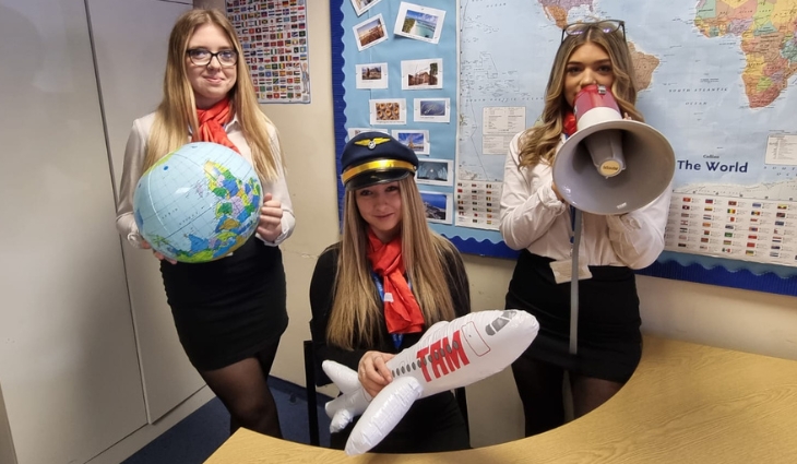 Photo of Level 3 travel students with inflatable props