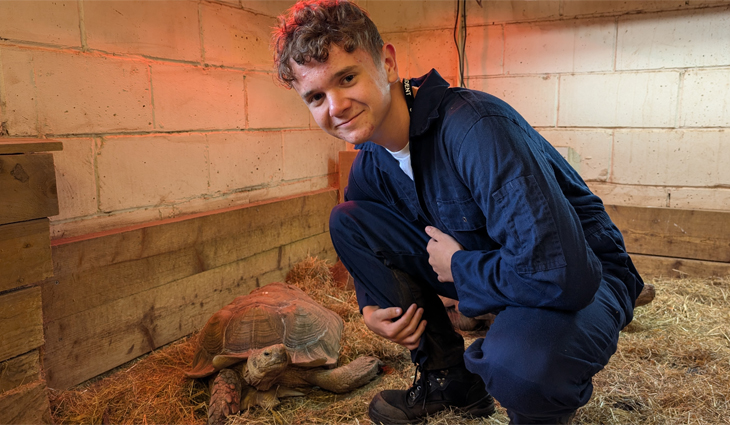 Photo of Animal Care student with Sulcata Tortoise