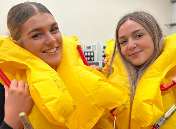 Travel students wearing life jackets at FlyMe Cabin Crew Training Day