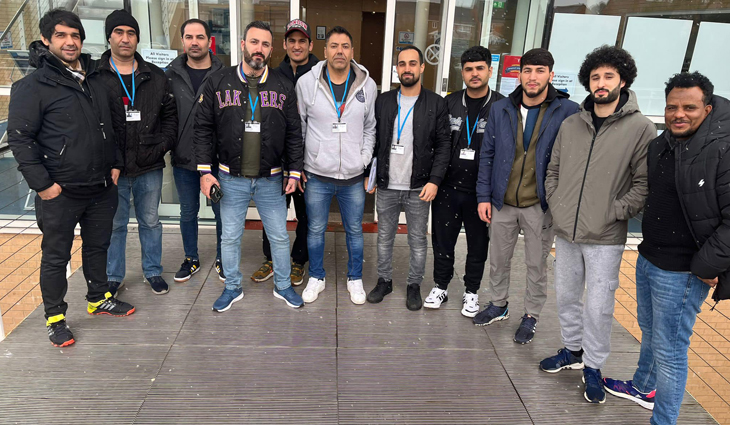 Group of ESOL students standing outside the front of Tamworth College