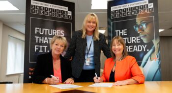 Claire Boliver signing IoT paperwork with the Principal of Stoke on Trent College