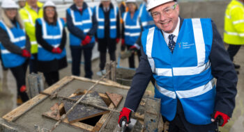 Kirk Hookham bricklaying on roof of new Tamwroth College