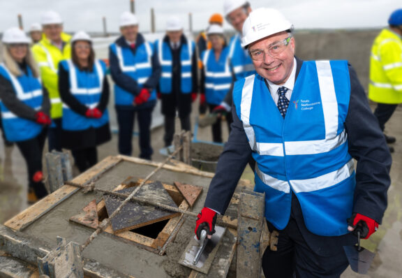 Kirk Hookham bricklaying on roof of new Tamwroth College