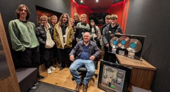 Chris Abbot in new music studio with music students